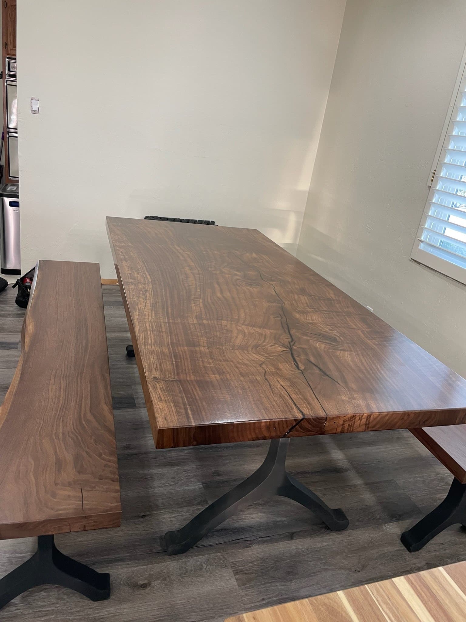 Custom live-edge walnut slab dining table