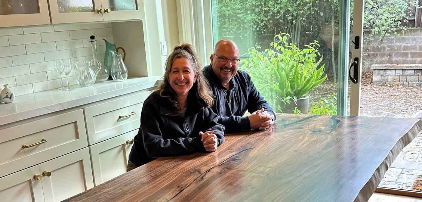 Clients seated at a custom live-edge walnut dining table